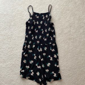 Women’s Hollister romper in Size XS. Black with multi-colored flowers.